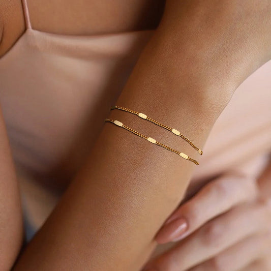 Gold bracelet on a wrist with a soft background