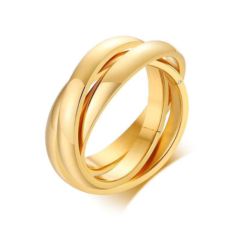 Gold ring with interlocking design on a white background