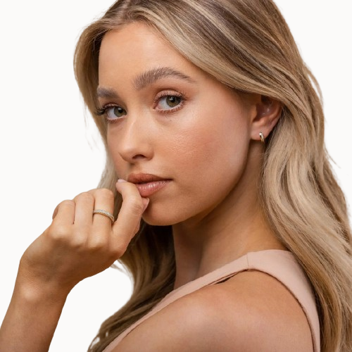 Woman with blonde hair and a neutral expression on a white background