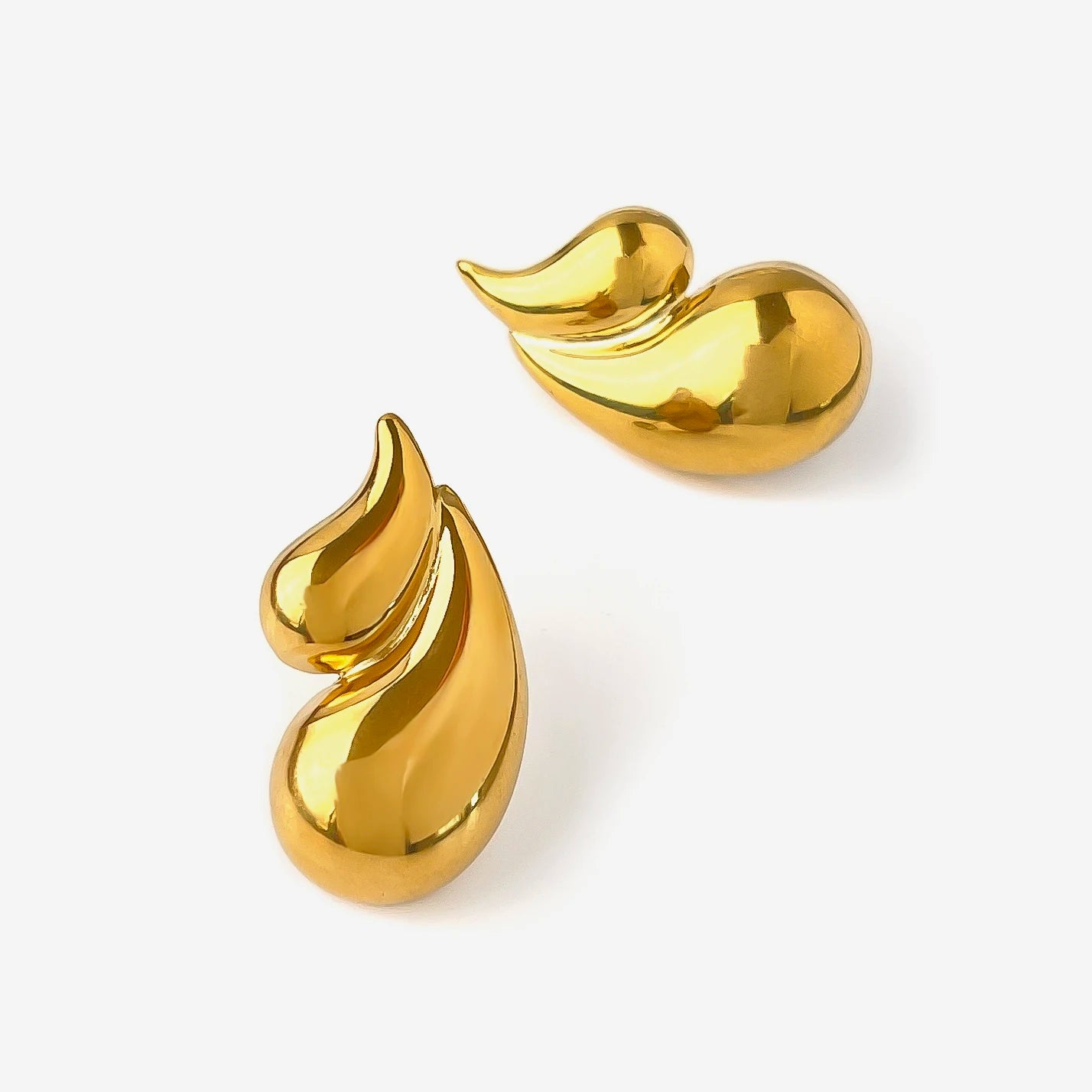 Pair of gold teardrop-shaped earrings on a white background