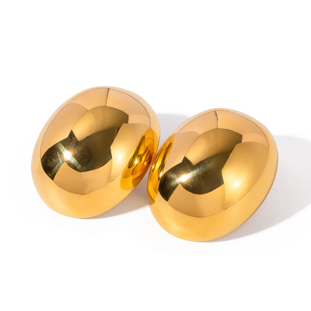 A pair of oval gold drop earrings with a polished finish.