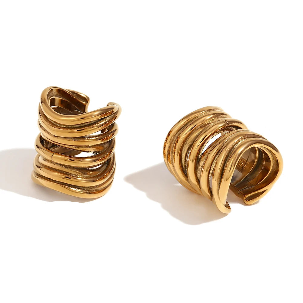 Gold spiral cuff earrings with measurements and material details on a white background