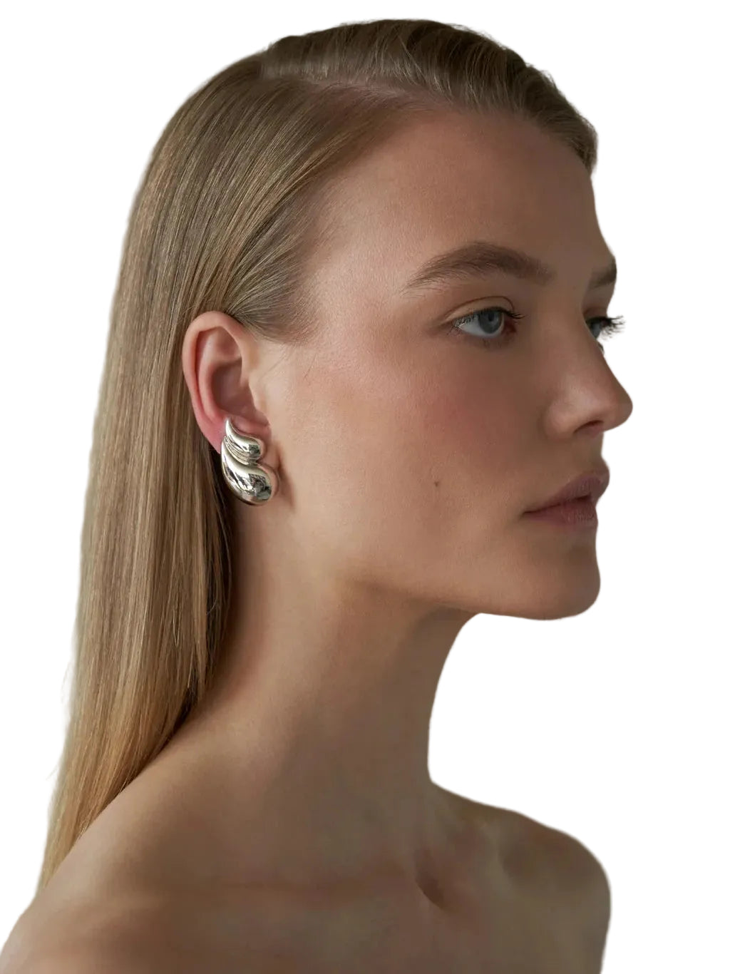 Woman wearing silver earrings with a White background