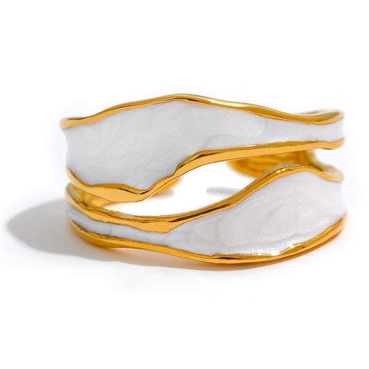 Gold and white marbled cuff bracelet on a white background