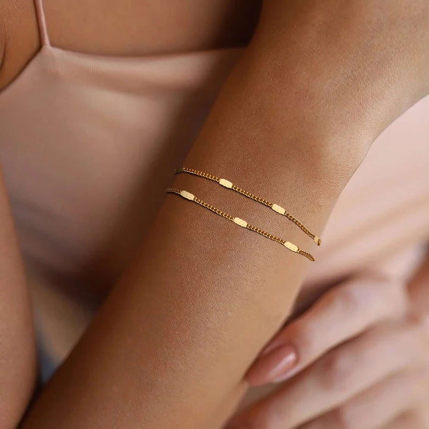 Gold bracelet on a wrist with a soft background
