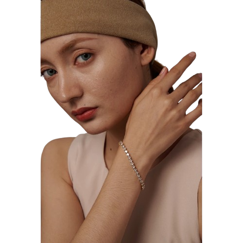 Woman wearing a beige headband and bracelet on a white background