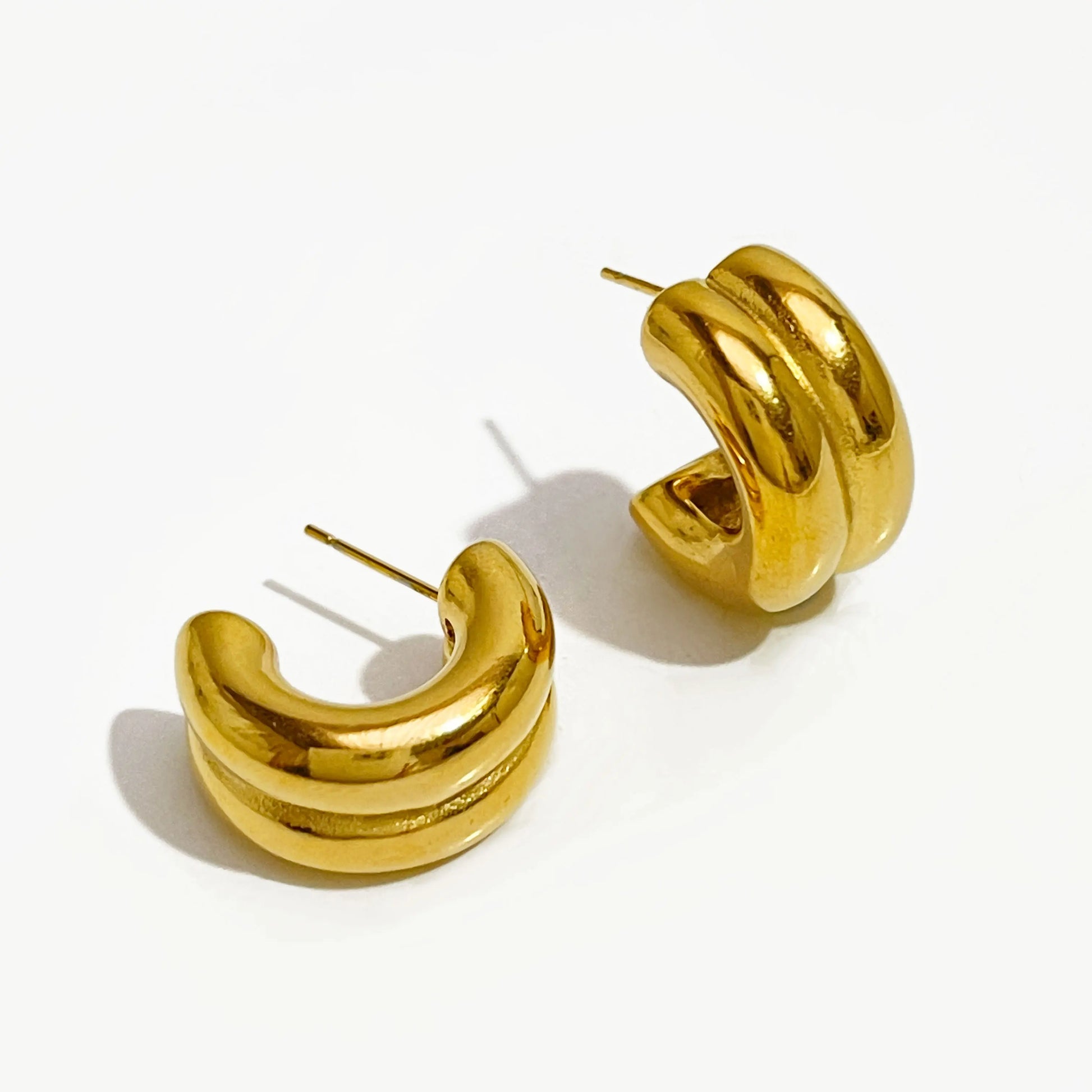 Gold hoop earrings on a white background