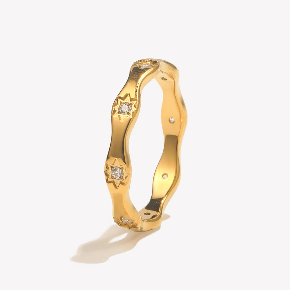 Gold ring with diamond accents on a white background