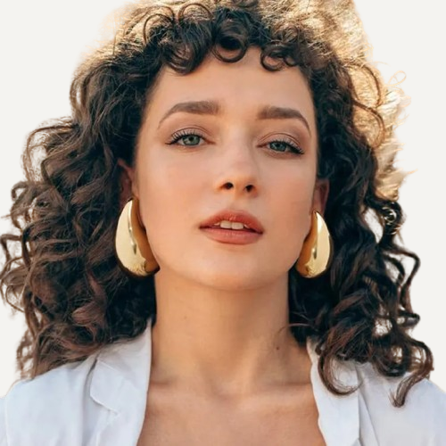 A pair of 18K gold plated stainless steel hoop earrings placed on a white surface.