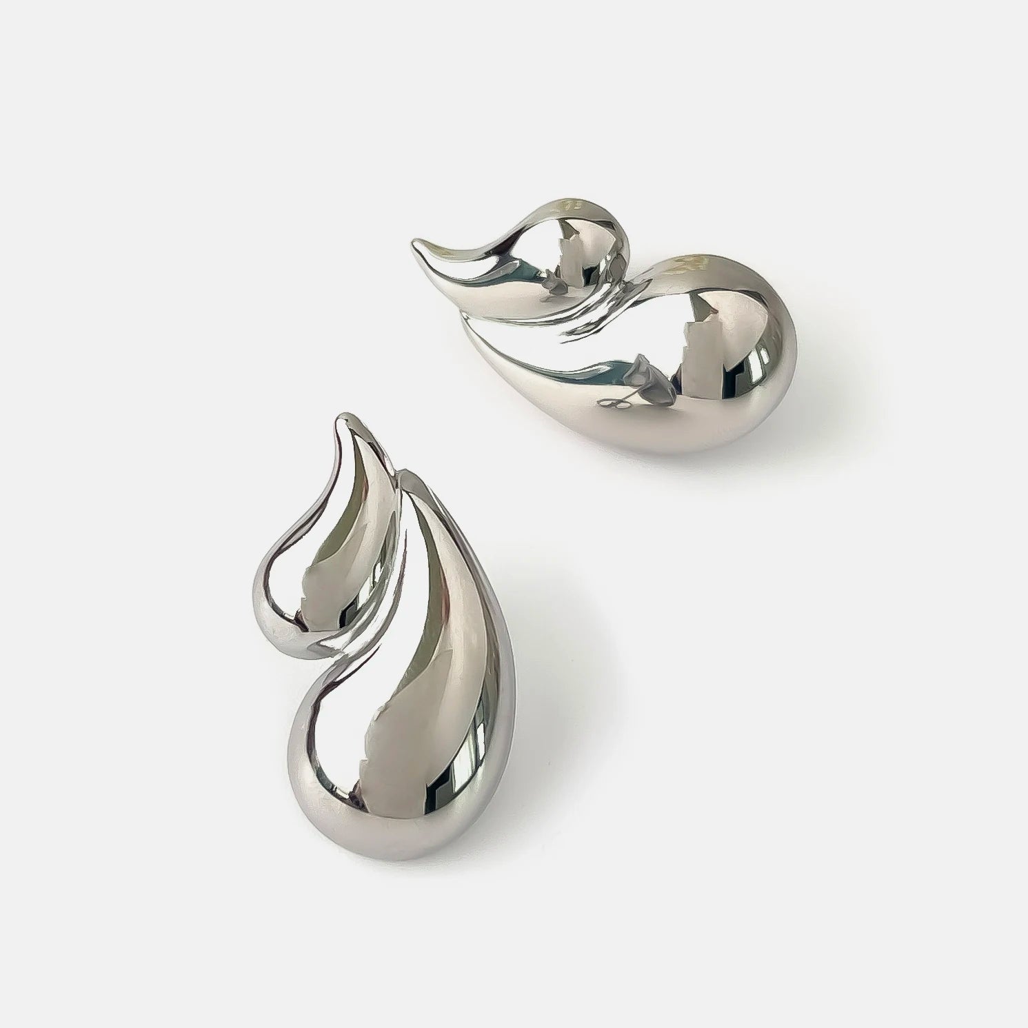 Pair of silver earrings on a white background